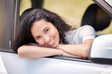 I love being on the road. Shot of a woman looking cheerful while on a road trip.