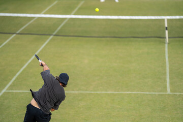 Amateur Tennis player, playing tennis at a tournament and match on grass in Europe 