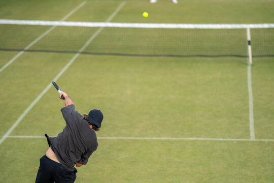 Amateur Tennis Player, Playing Tennis At A Tournament And Match On Grass In Europe 