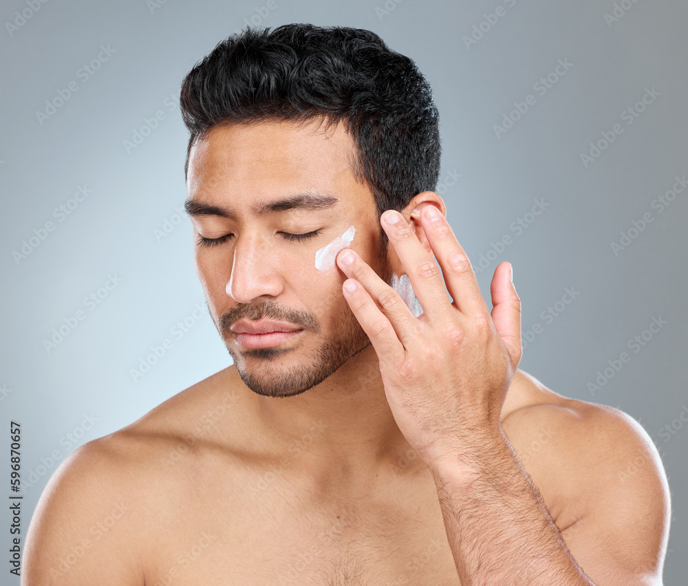 Poster theres nothing wrong with taking care of yourself. shot of a man applying moisturiser to his face wh