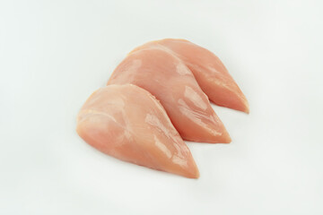 Raw fresh chicken fillet on a white background.Copy space.Raw Chicken breast Fillets.Food for retail.Procurement for designers.Ogranic food,healthy eating.Food concept.Top view.Close up.