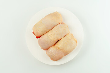 Chicken leg meat.Raw fresh chicken leg meat with skin on white background.Food for...