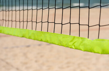 Beach volleyball and beach tennis net on the background of sand. Sport team concept. Horizontal sport theme poster, greeting cards, headers, website and app