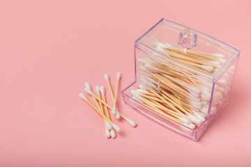 Eco-friendly cotton swab, bamboo cotton buds on a pink background. Waste-free cosmetics without plastic. Eco goods. hygiene. Place for text. Place to copy.