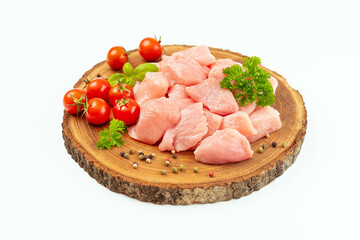 Ogranic food and healthy eating.chicken fillet.Fresh pieces of turkey meat.Raw chicken.Raw pieces of turkey meat with greens and tomatoes on a wooden board against a white background.