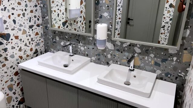 Hotel bathroom with colorful marble walls and two wash basins