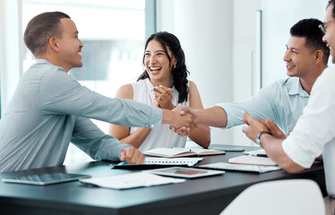 Lots of opportunities will grow from this. Shot of businesspeople shaking hands during a meeting in an office.