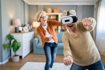 Women two senior females at home enjoy virtual reality VR headset