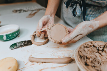 Close up of female hands working with clay