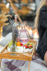 Romantic picnic with wine, cheese, lavender, strawberry