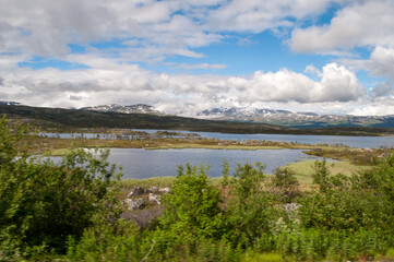 Fototapeta na wymiar Lakes in Abisko National Park in northern Sweden. Landscape with mountains and hills.