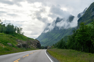 Naklejka premium Empty road in the cloudy mountains in the north of Europe in Norway