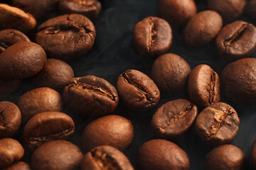 Coffee beans on a black background. Coffee on a black background with reflection