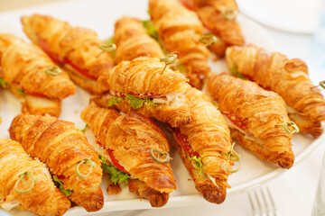 croissants stuffed with vegetables and meat. delicious snack.