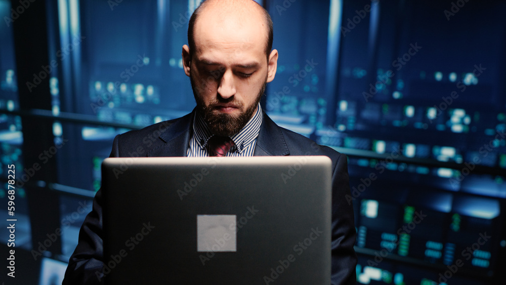 Poster system administrator checking cluster computer service holding laptop in modern server room. data ce