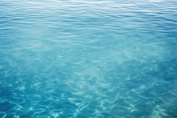 Fototapeta na wymiar Beautiful light reflections in a crystal clear transparent water surface in a blue hue is a beautiful background image with space for text