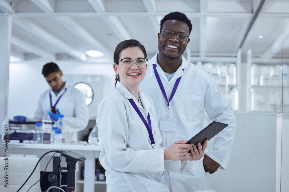 Canvas Prints Nothing will stop them. Shot of two colleagues working together on a scientific project using a digital tablet.