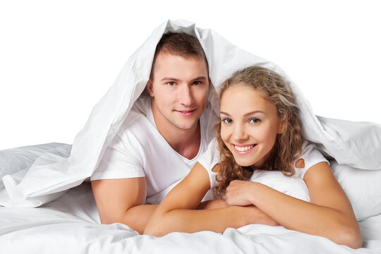 A young man with a cute woman in bed at the home