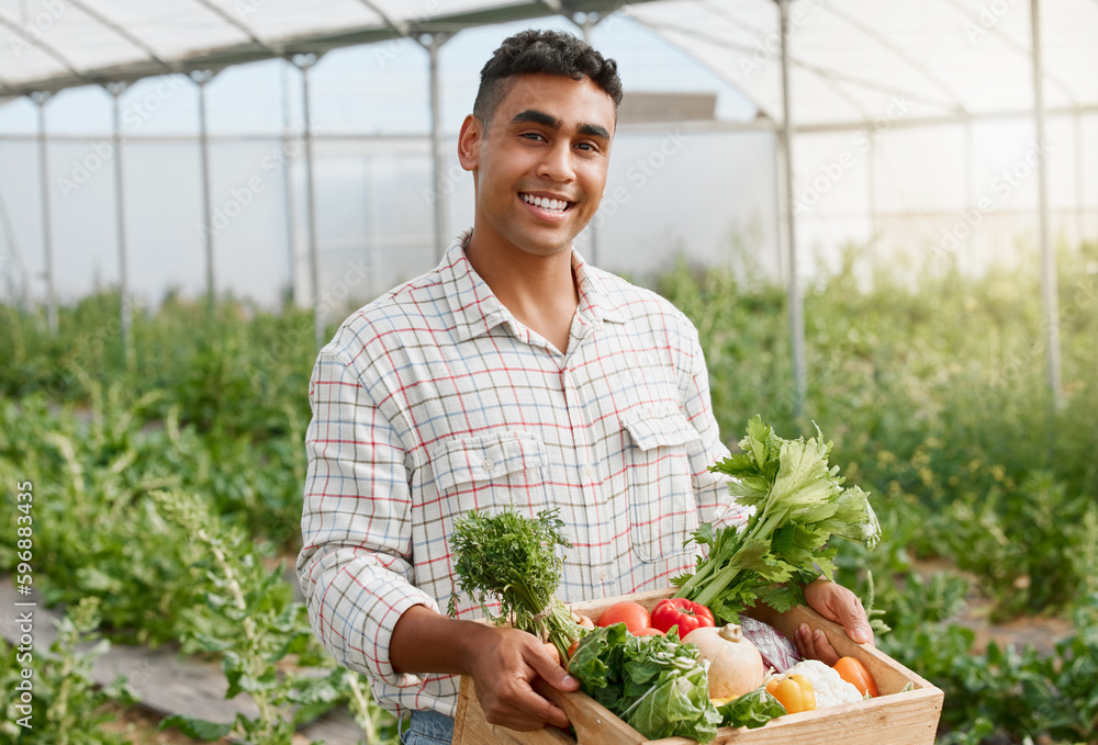 Poster You can create many delicious dishes with these. Portrait of a young man holding a crate of fresh produce while working on a farm.