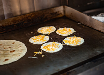 Corn Tortillas with cheese on Food Truck Grill, Stove