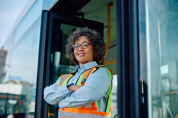 Portrait of confident female bus driver looking at camera.