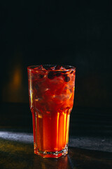 cocktail on a dark background with ice and fruits. menu format
