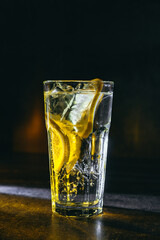 cocktail on a dark background with ice and fruits. menu format
