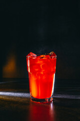 cocktail on a dark background with ice and fruits. menu format
