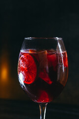 cocktail on a dark background with ice and fruits. menu format
