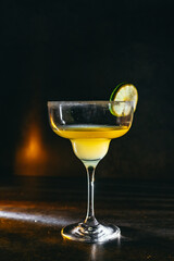 cocktail on a dark background with ice and fruits. menu format
