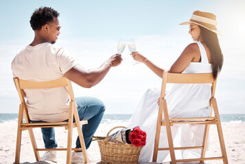 To us. Shot of a young couple celebrating their engagement at the beach.