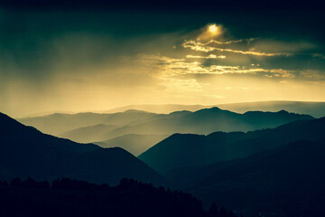 banner of mountain peaks in beautiful stormy sunset light