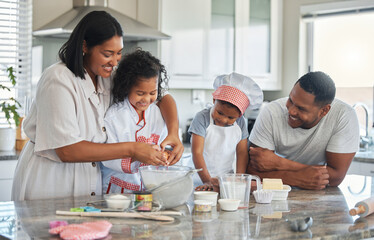 Fototapeta na wymiar Love is a key ingredient. Shot of a couple baking at home with their two children.