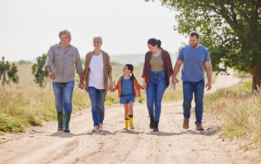Raising a family of farmers. Shot of a multi-generational family walking together on a farm.