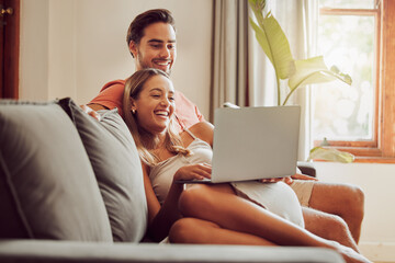 Together is the best place to be. Shot of a young couple using a laptop together at home.