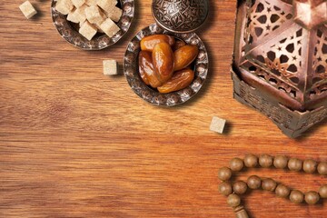 Plate with dates tasty sweets on wooden desk