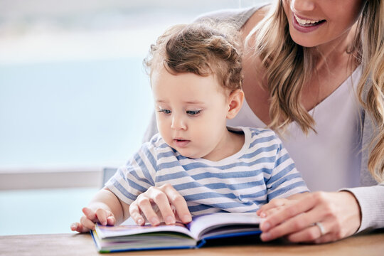 Start reading to them from a young age. Shot of a mom reading to her son at home.