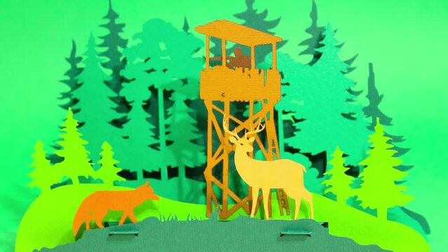 Paper stop motion animation. A soldier on a tower with a weapon turns into a forester in the forest, deer, forest beasts deer and fox appear