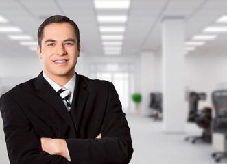 Portrait of the successful young male businessman in office building