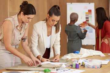 Fototapeta premium Hard at work. Shot of a group of female designers working in an office.