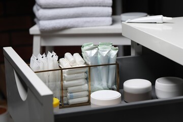 Storage of different feminine and personal care products in drawer indoors