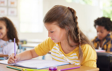 Colouring is the perfect time to practice naming the colours. Shot of a preschooler colouring in class.