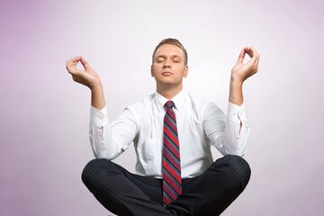 Happy young business man having relaxation and meditating