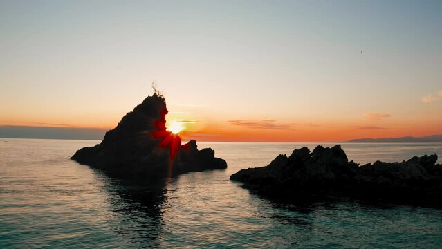 Warm sunset among the rocks of the sea