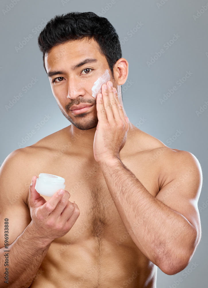 Sticker take care of your skin. shot of a man applying moisturiser to his face while standing against a grey