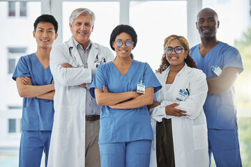 We are each competent and have a vital contribution to share. Portrait of a group of medical practitioners standing together with their arms crossed in a hospital.