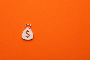 White money bag on orange color background - money bag icon with a dollar sign, graphic resource...