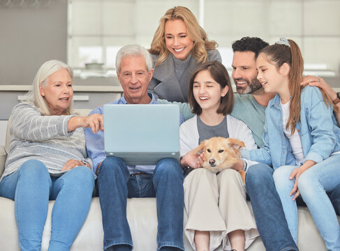 Family planning. Shot of a family using a laptop while sitting on a sofa together at home.