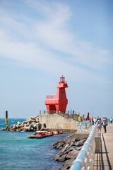 Fototapeta na wymiar Wonderful Iho Tewoo Beach two horse shaped lighthouses. Jeju Island, South Korea