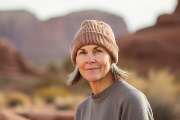Portrait of a middle-aged woman in a hat in the desert